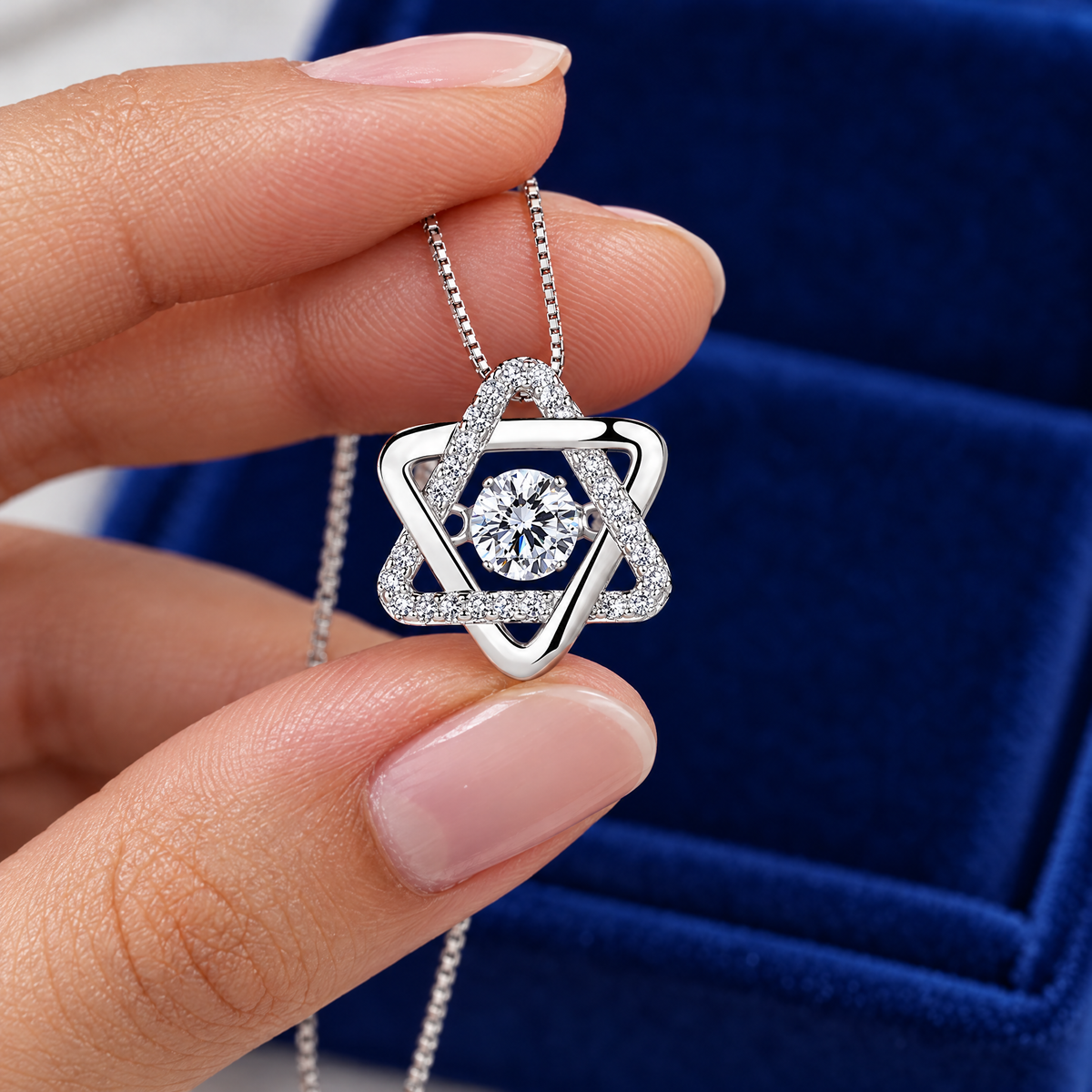 Moissanite Star of David pendant held between two fingers to show its size