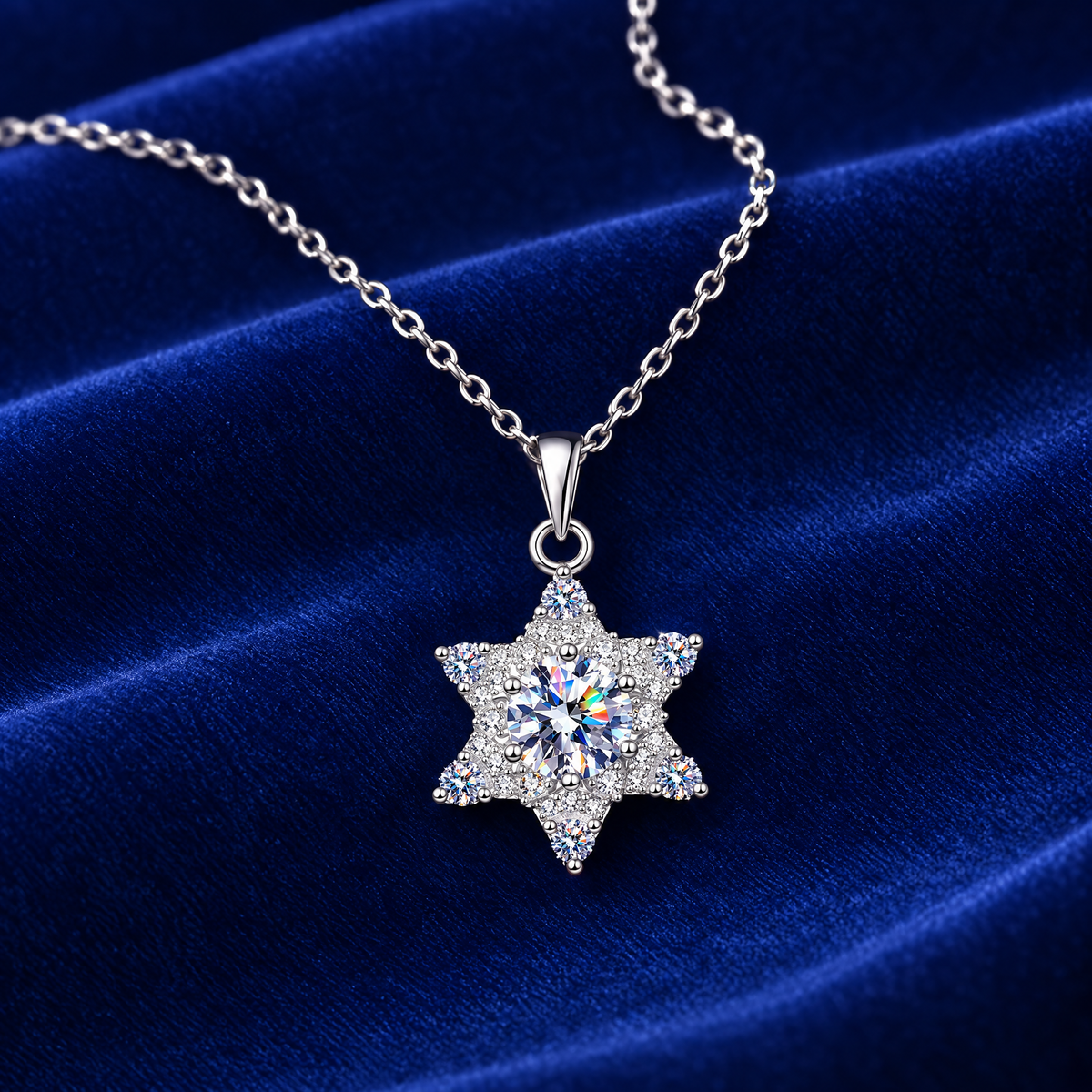 1 carat moissanite star pendant on royal blue velvet