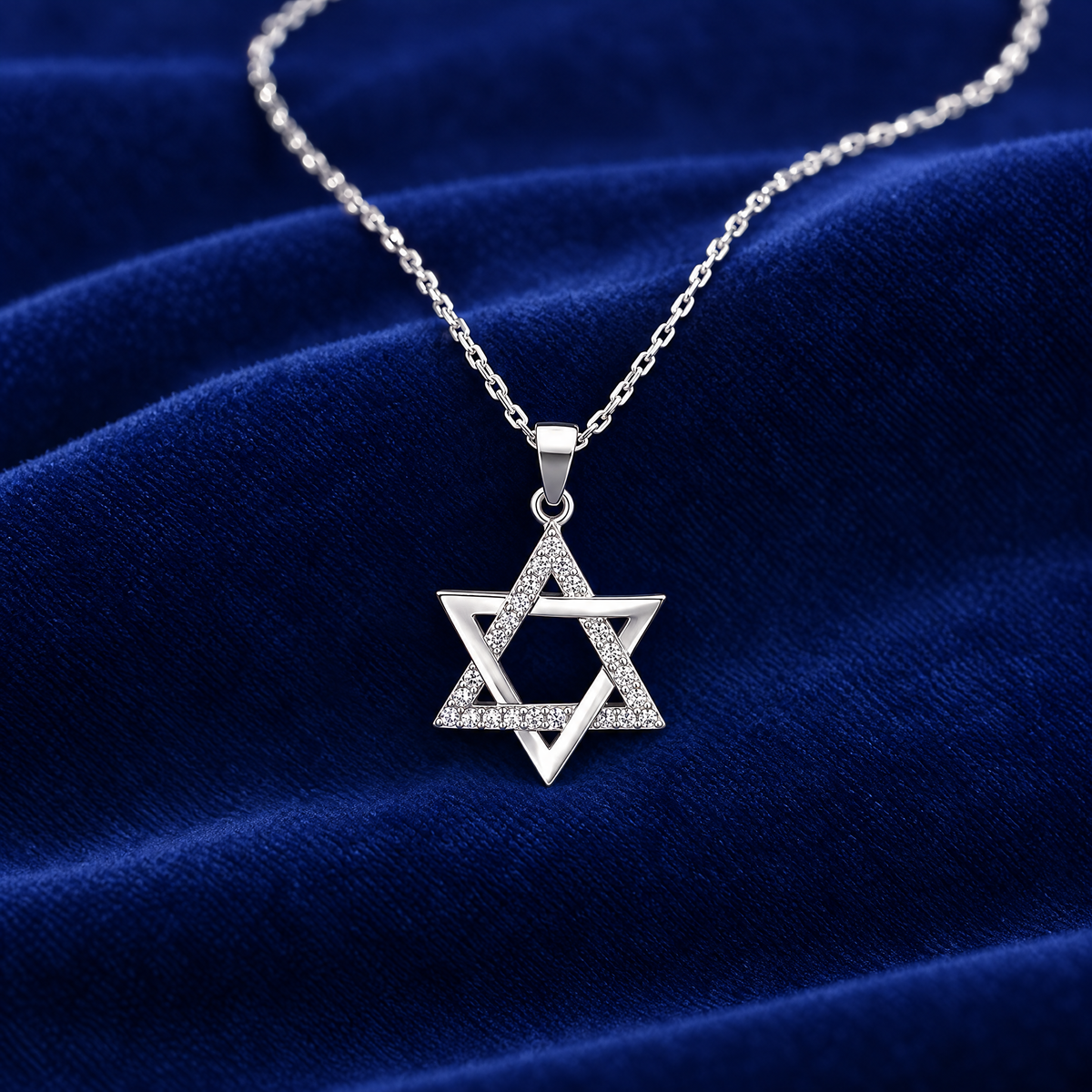 Open sterling silver Star of David on royal blue velvet