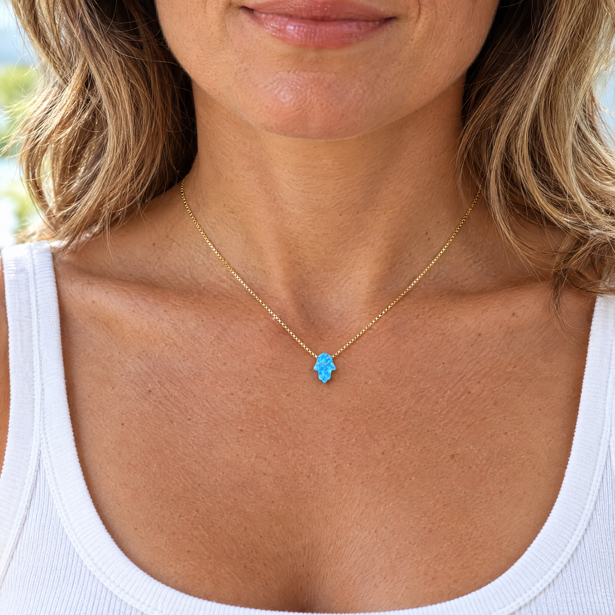 Blue opal hamsa necklace worn, shown at real size (8 x 10 mm)