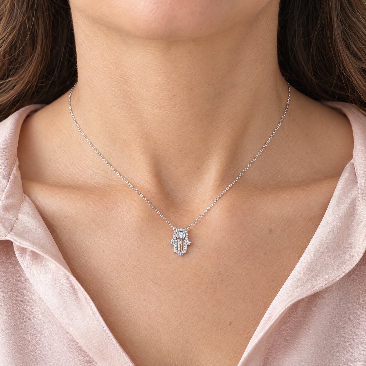 Pavé hamsa necklace in sterling silver worn, shown at real size (15 x 12 mm)