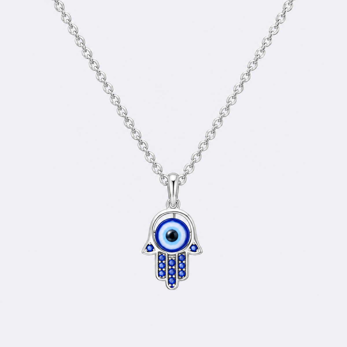Sterling silver hamsa necklace with blue eye, studio photo