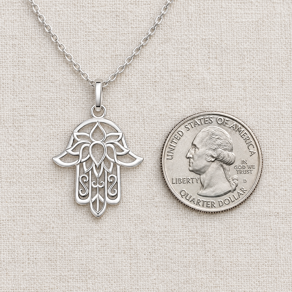 Lace hamsa necklace in sterling silver next to a US quarter, to show its real size (27 x 19.5 mm)
