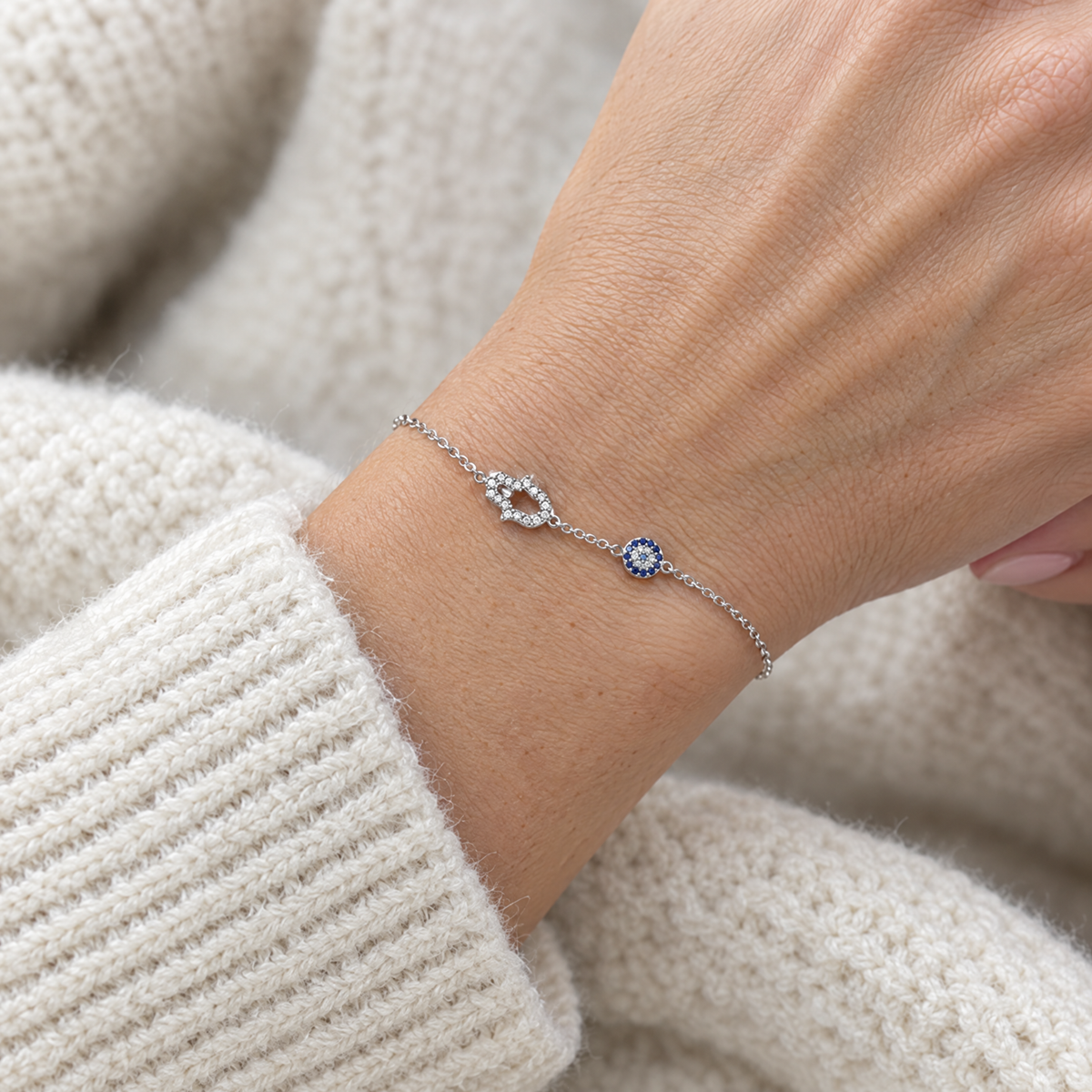 Hamsa and blue eye bracelet in sterling silver worn, shown at real size (10 mm hamsa)