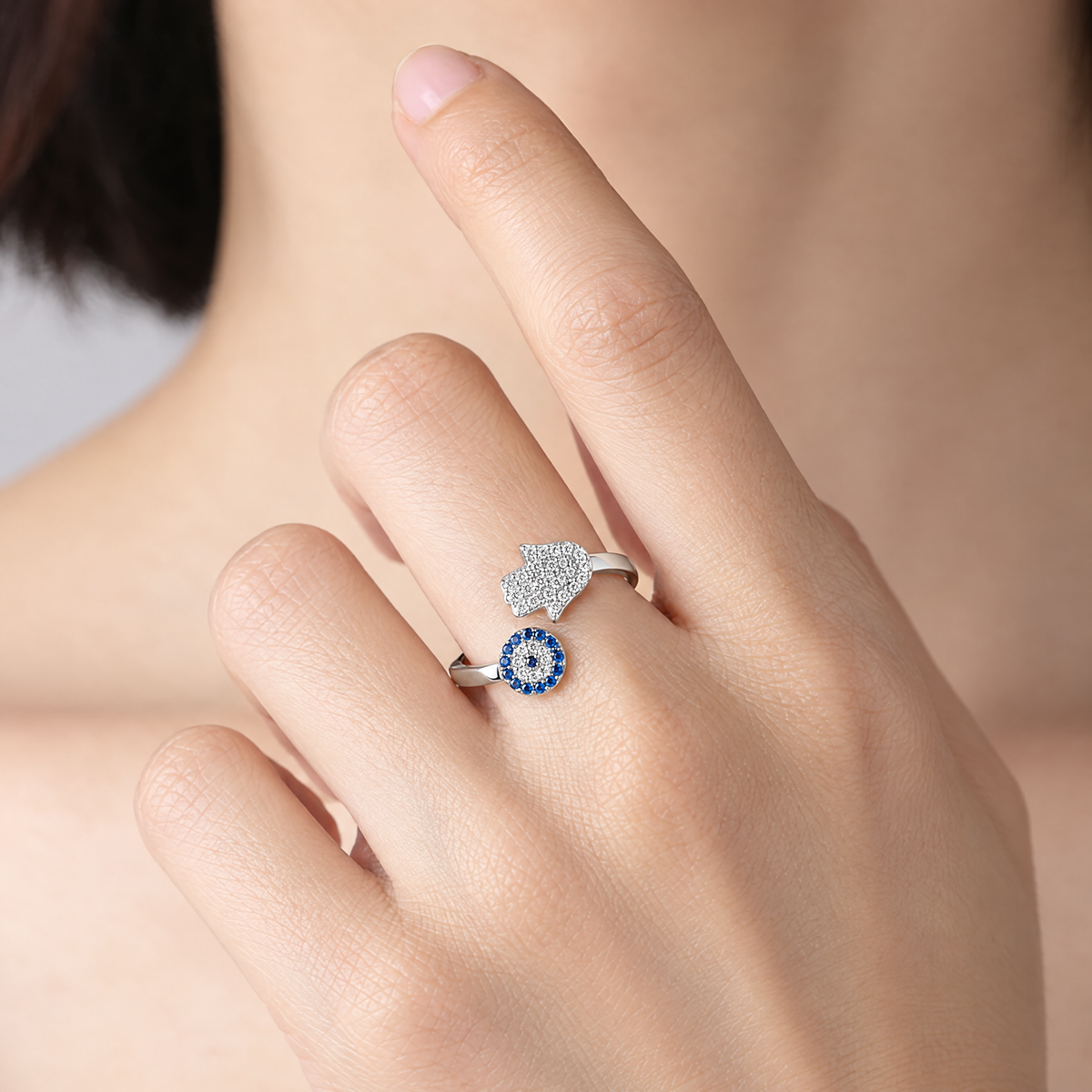 Adjustable hamsa and blue eye ring in sterling silver worn, shown at real size (9 mm hamsa)