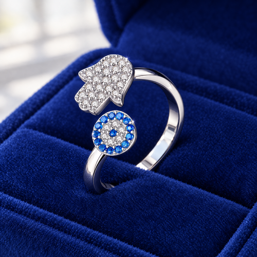Adjustable hamsa and blue eye ring in sterling silver on royal blue velvet