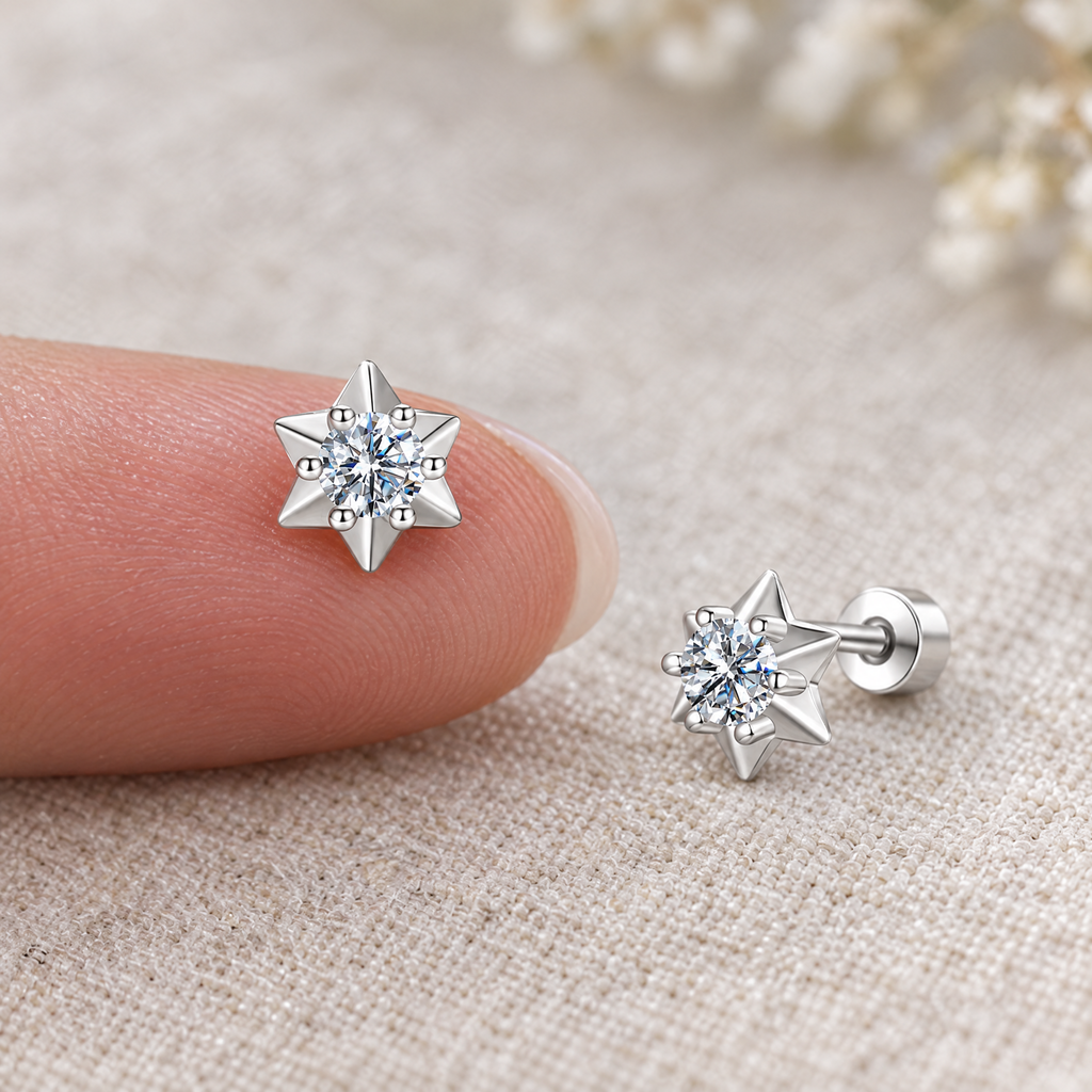 Moissanite star stud earring on a fingertip, to show its real size (6 mm)