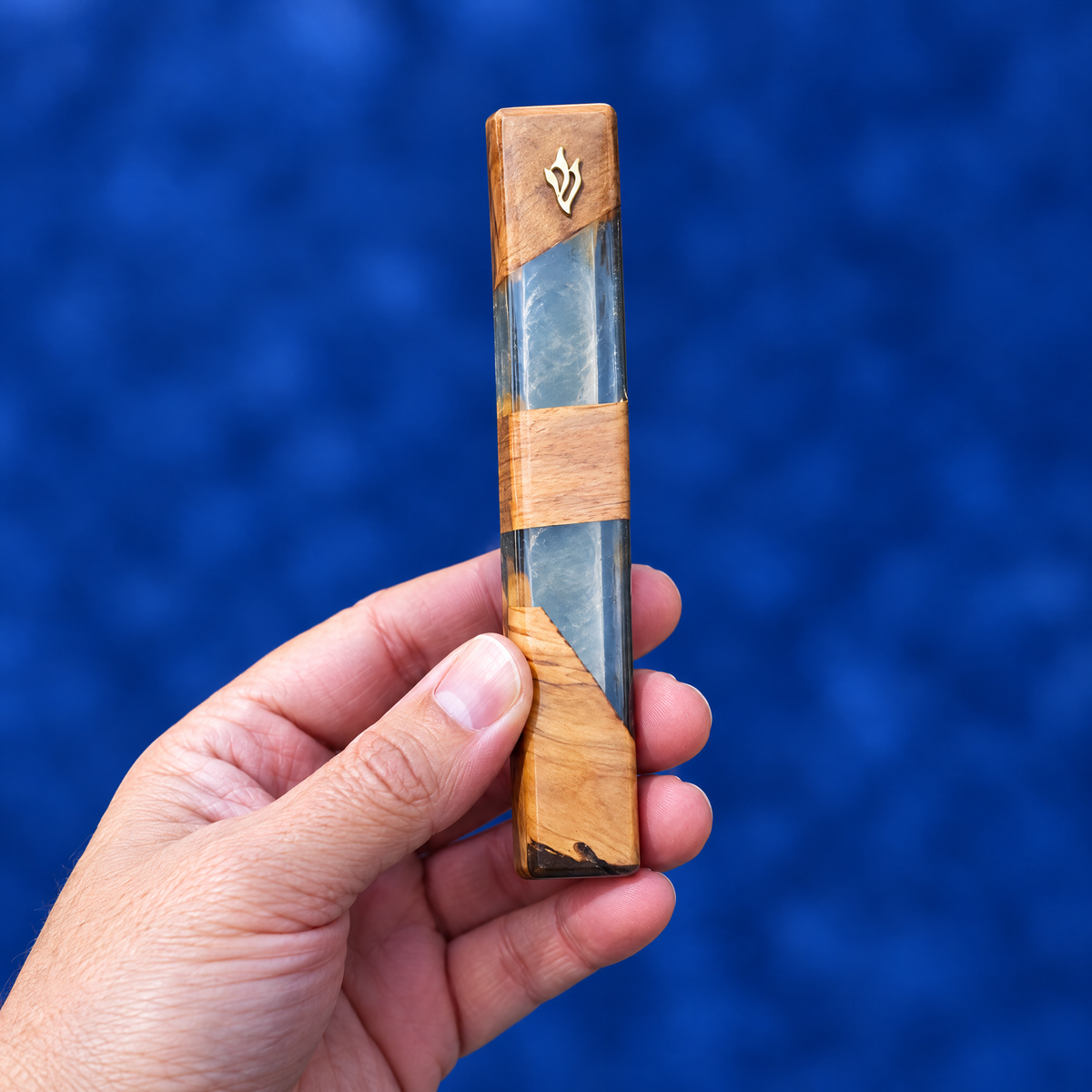 Mini olive wood mezuzah case in the hand, to show its real size (14 x 2.5 cm)