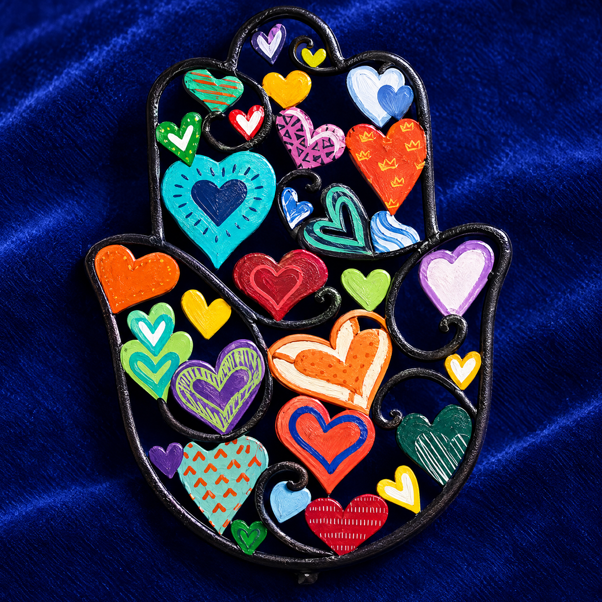 Colorful hamsa wall art, close-up of the painted hearts