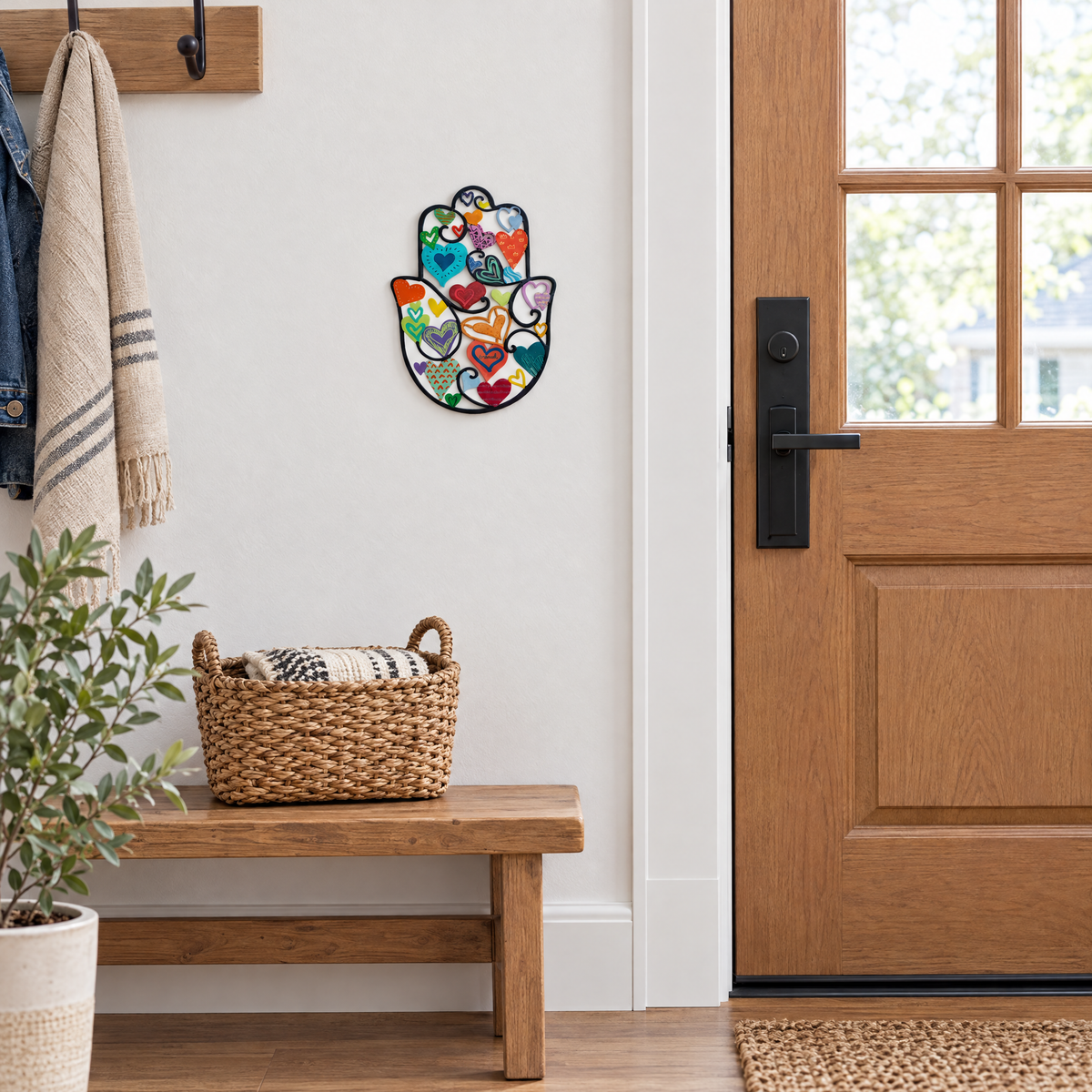 Colorful hamsa wall art by a front door, shown at real size (18.5 x 25 cm)