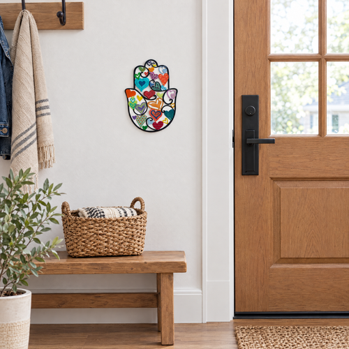 Colorful hamsa wall art by a front door, shown at real size (18.5 x 25 cm)